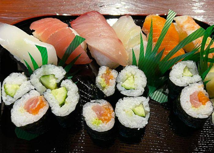 A selection of maki and nigiri sushi, featuring fresh fish and veggies.